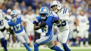 Greg Dortch #8 of Detroit Lions runs with the ball while defended by Rob Carter Jr. #39 of the Indianapolis Colts at Lucas Oil Stadium on August 29, 2026 in Indianapolis, Indiana.