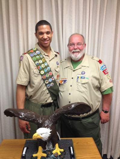 Josh Hart poses in his Scout uniform with a Scout Troop 1083 leader after becoming an Eagle Scout.