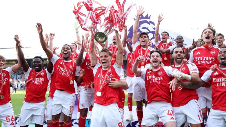Martin Odegaard of Arsenal lifts the Premier League trophy as players of Arsenal celebrate, as they are crowned the Champions of the Premier League for the 2025/26 Season, after the Premier League match between Crystal Palace and Arsenal at Selhurst Park on May 24, 2026 in London, England