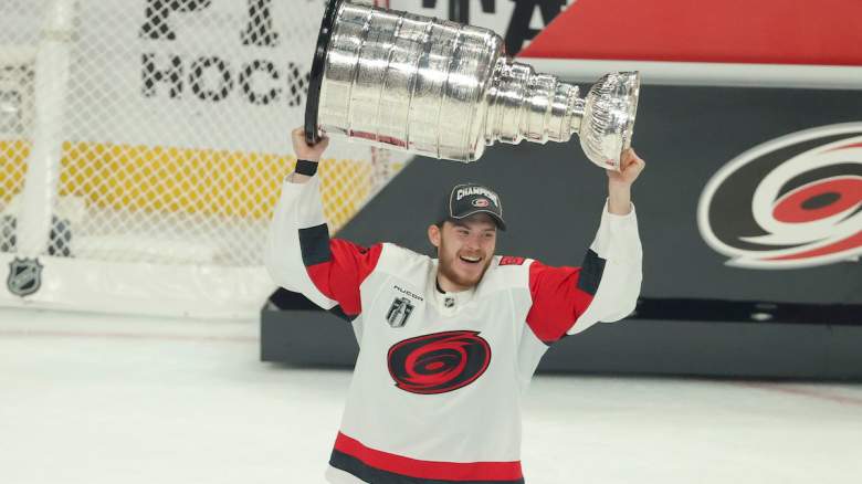 Alexander Nikishin #21 of the Carolina Hurricanes lifts the Stanley Cup