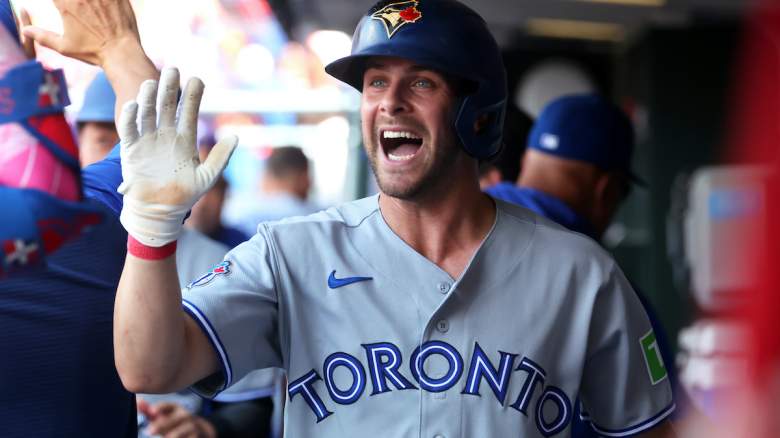 Ernie Clement #22 of the Toronto Blue Jays high fives teammates