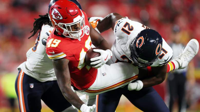 Tight end Tre Watson #49 of the Kansas City Chiefs is picked up by safety Mark Perry #21 and linebacker Carl Jones #43 of the Chicago Bears during the NFL Preseason 2025 game at Arrowhead Stadium on August 22, 2025