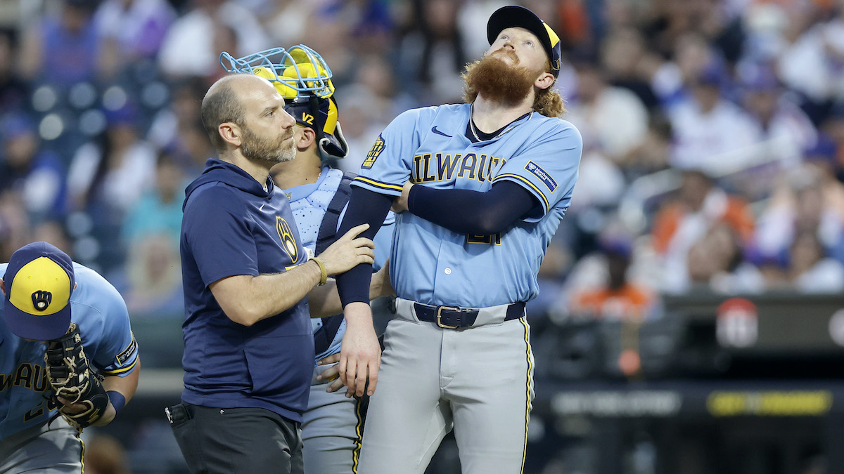 A trainer checks on Dustin May