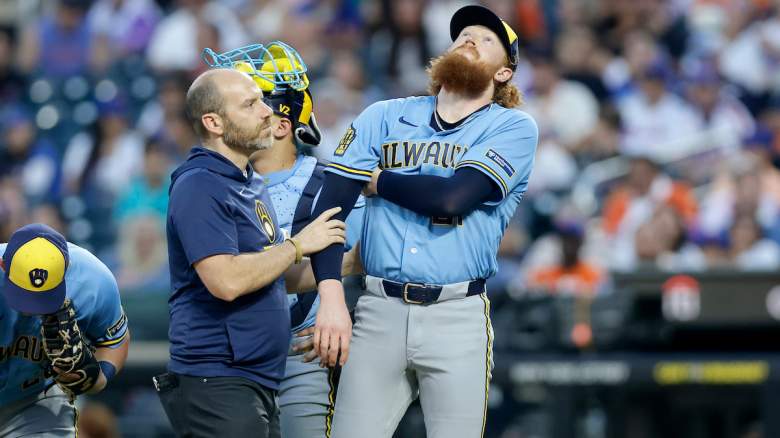 A trainer checks on Dustin May