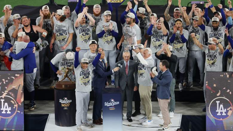 Los Angeles Dodgers owner Mark Walter raises the Commissioner's Trophy