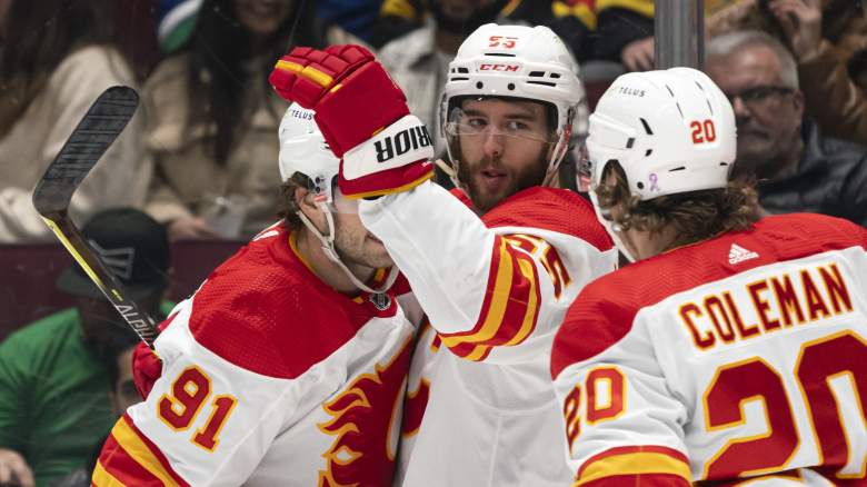 Noah Hanifin #55 of the Calgary Flames celebrates with teammates Calle Jarnkrok #91 and Blake Coleman #20 after scoring a goal against the Vancouver Canucks during the first period in NHL action on March, 19, 2022 at Rogers Arena in Vancouver, British Columbia, Canada.