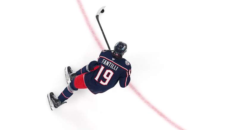 An overhead shot of Adam Fantilli skating near a faceoff circle.