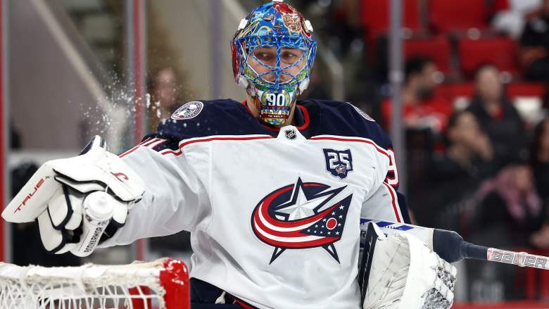 Elvis Merzlikins of the Blue Jackets leans on the goal.