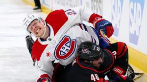 Kaiden Guhle #21 of the Montr&eacute;al Canadiens collides with Jordan Martinook #48 of the Carolina Hurricanes during the second period in Game Five of the Eastern Conference Final of the 2026 Stanley Cup Playoffs at Lenovo Center on May 29, 2026 in Raleigh, North Carolina.