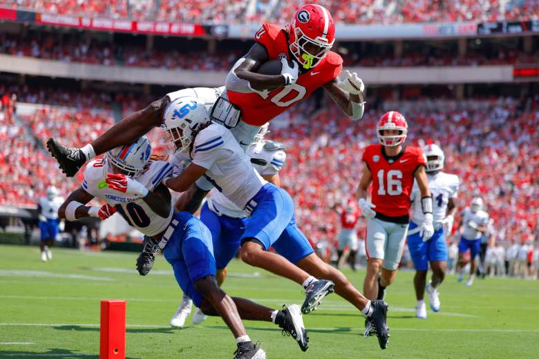 Elyiss Williams flies over two Tennessee State defenders for Georgia.