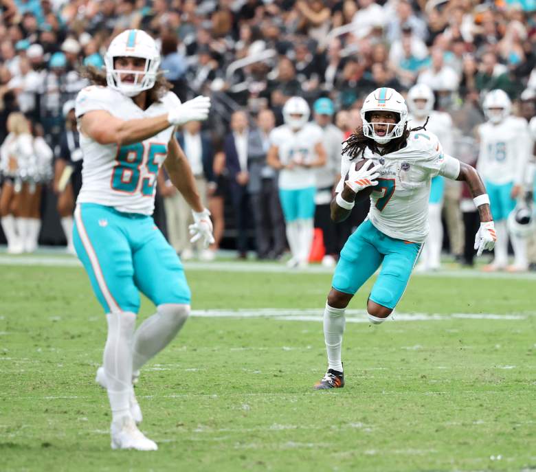Caleb Douglas runs behind the block of Greg Dulcich for the Dolphins.