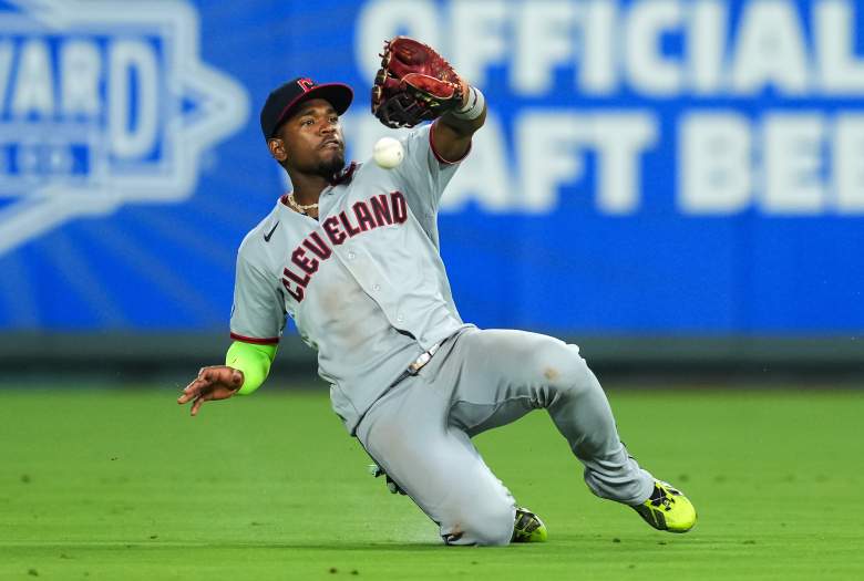 Angel Martinez slides for the Guardians in the outfield.