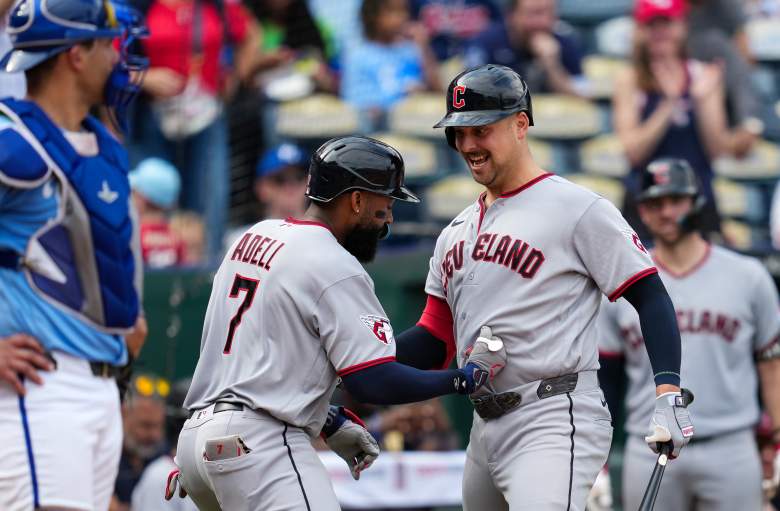 Jo Adell and Nathaniel Lowe celebrate for the Guardians.