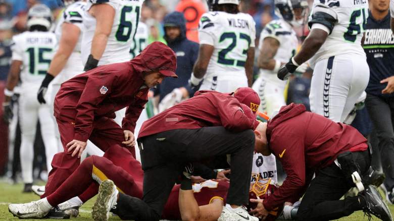 Leo Chenal #54 of the Washington Commanders goes down with injury against the Seattle Seahawks during the second quarter at Northwest Stadium on September 27, 2026 in Landover, Maryland