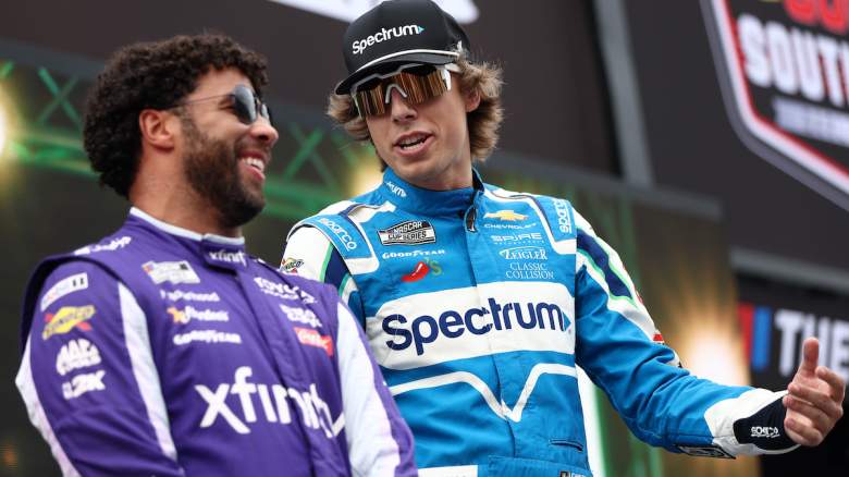 Carson Hocevar, driver of the #77 Spectrum Chevrolet, (R) and Bubba Wallace, driver of the #23 Xfinity Toyota, talk onstage