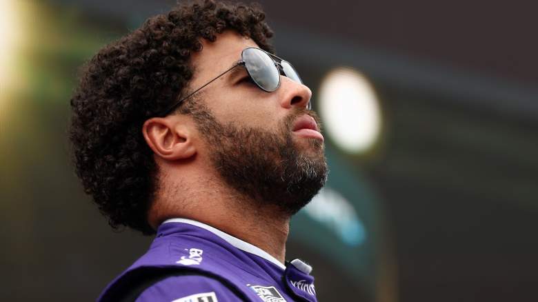 Bubba Wallace, driver of the #23 Xfinity Toyota, stands onstage