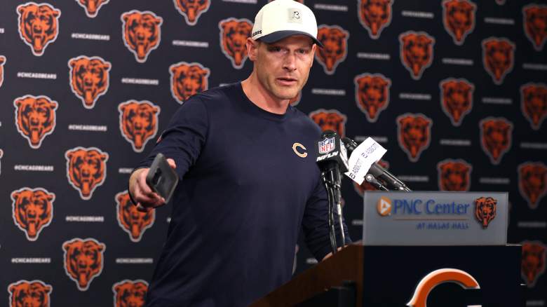 Head coach Ben Johnson of the Chicago Bears hands a phone