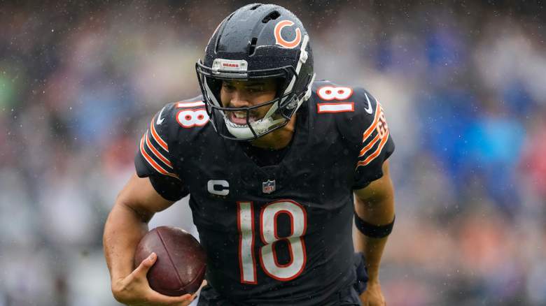 Caleb Williams #18 of the Chicago Bears scrambles with the ball