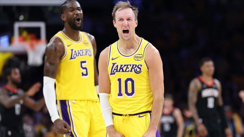 Deandre Ayton #5 and Luke Kennard #10 of the Los Angeles Lakers reacts after making a three point shot