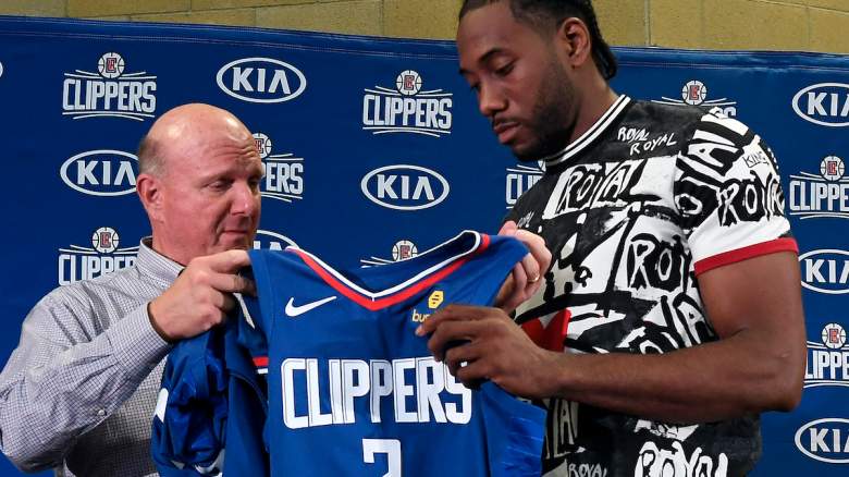 Los Angeles Clippers owner Steve Ballmer hands Kawhi Leonard his jersey