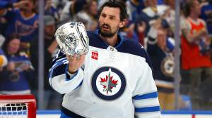 Connor Hellebuyck #37 of the Winnipeg Jets reacts