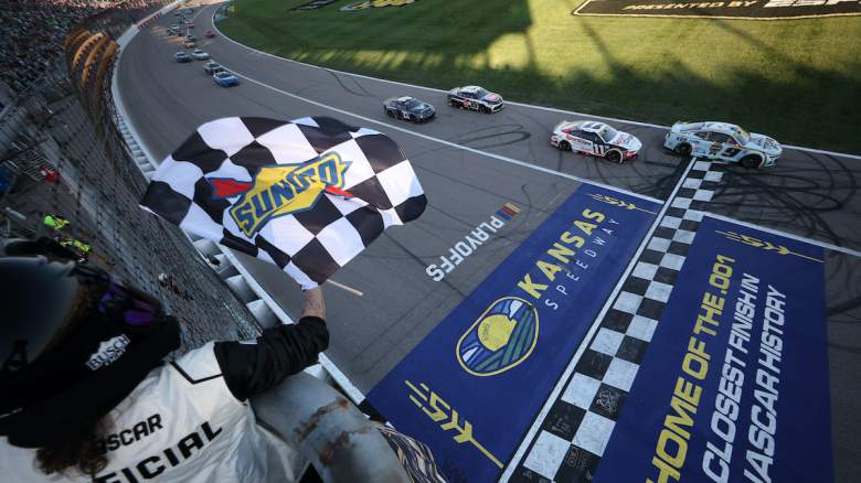 Chase Elliott, driver of the #9 Kelley Blue Book Chevrolet, takes the checkered flag