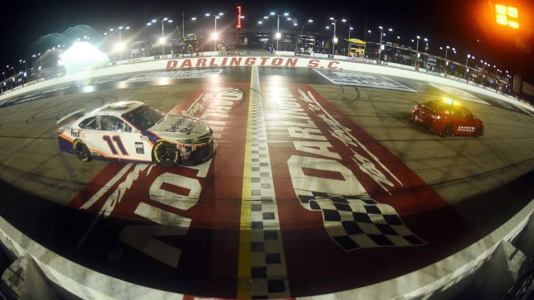 Race car under caution to later win the rain-shortened NASCAR Cup Series.