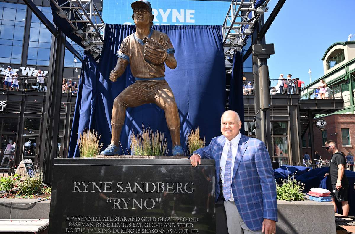 Former Chicago Cubs player and Hall of Famer Ryne Sandberg poses for pictures in front of his statue