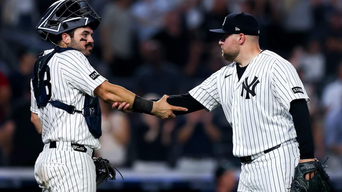 Austin Wells #28 and David Bednar #53 of the New York Yankees celebrate