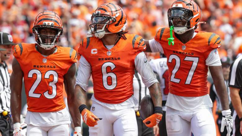 Bryan Cook celebrates with Bengals teammates Dax Hill and Jordan Battle