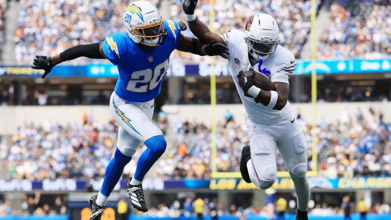 Los Angeles Chargers cornerback Cam Hart defends against Arizona Cardinals running back Jeremiyah Love at SoFi Stadium.
