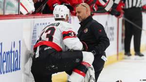 Nikolas Matinpalo #33 of the Ottawa Senators is attended to by a trainer after being hit by Anthony Mantha #39 of the New Jersey Devils (not pictured) during the first period of a NHL game at Prudential Center on October 12, 2026 in Newark, New Jersey.