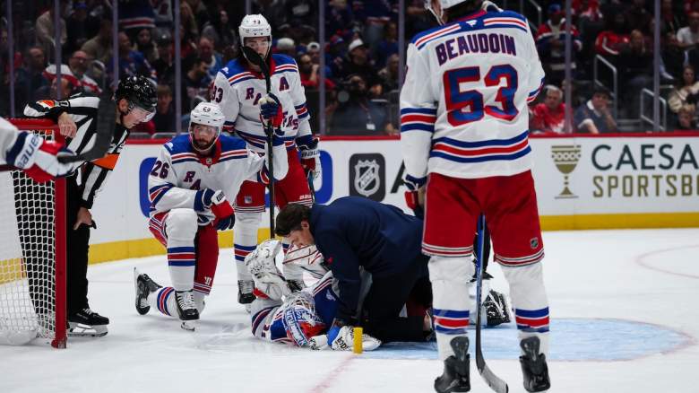 Igor Shesterkin #31 of the New York Rangers receives attention on the ice