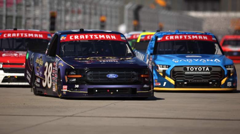 Chandler Smith, driver of the #38 Hard Rock Casino Tejon/Hard Rock Cafe Ford, and Jimmie Johnson, driver of the #1 Carvana Toyota, race during the NASCAR Craftsman Truck Series