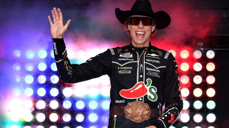 Carson Hocevar, driver of the #77 Chili's Ride the 'Dente Chevrolet, waves to fans as he walks onstage