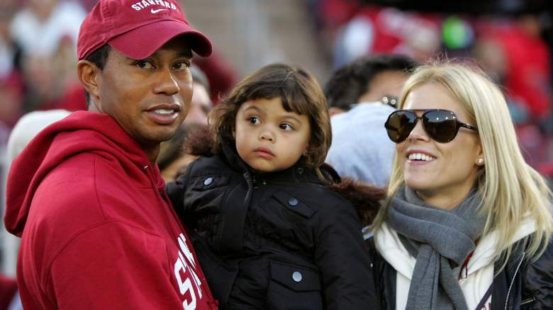 Honorary Standford Cardinal captain Tiger Woods holds his daugher, Sam, and stands next to his wife, Elin Nordegren, on the sidelines before the Cardinal game against the California Bears at Stanford Stadium on November 21, 2009