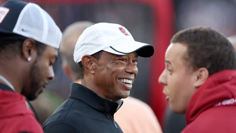 Tiger Woods smiles while talking with people on the sideline at a Stanford football game on September 4, 2026.