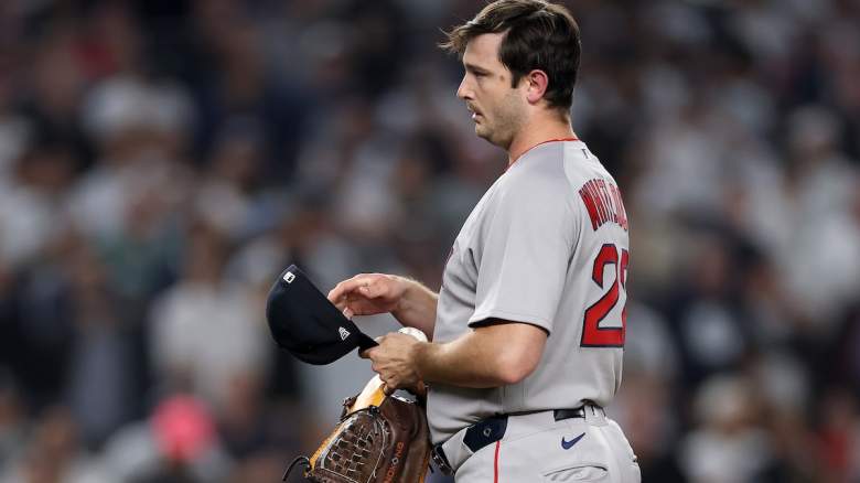 Garrett Whitlock #22 of the Boston Red Sox adjusts the PitchCom device in his hat against the New York Yankees