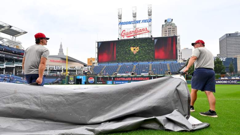 The Cleveland Guardians grounds crew removes the tarp