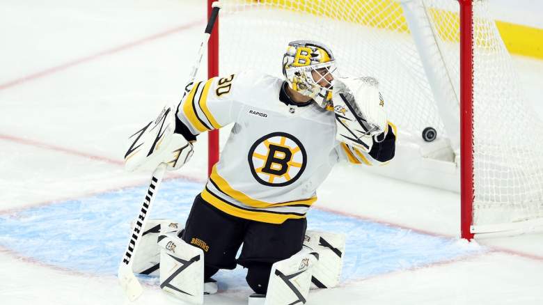 A puck shot by Jared Spurgeon #46 of the Minnesota Wild (not pictured) goes past Michael DiPietro #30 of the Boston Bruins