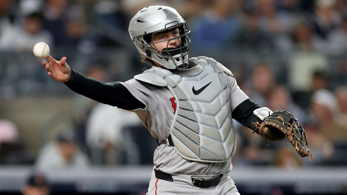 Adley Rutschman #31 of the Boston Red Sox throws to first base